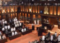 පාර්ලිමේන්තුව මැද මන්ත්රීවරුන්ගෙන් උණුසුම් විරෝධයක්!  හැන්සාඩ් වාර්තාවෙන් වචනයක් ඉවත් කරන්නත් සිද්ධ වෙලා!  මොකක්ද මේ පිටිපස්සේ තියෙන රහස?